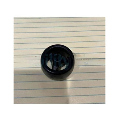 Black cylindrical object on lined paper