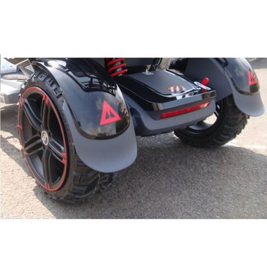 Close-up of a black and red three-wheeled vehicle on a paved surface