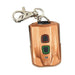 Copper-colored remote control keychain with a clasp on a white background