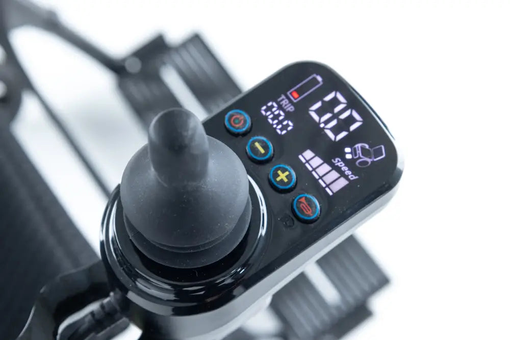Close-up of the Monarch Mobility Ezi-Fold Carbon joystick controller with digital speed, trip, and battery displays.