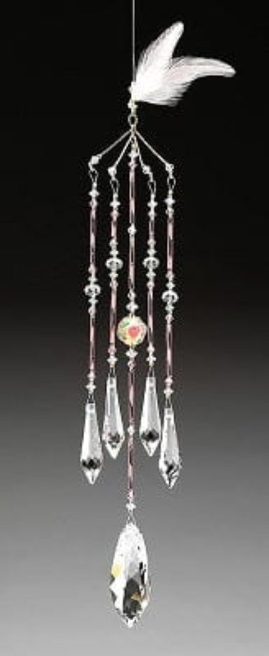 Crystal wind chime with hanging leaf on a gradient background