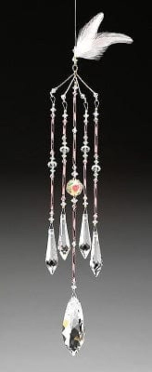 Crystal wind chime with hanging leaf on a gradient background