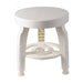 White round stool with decorative legs on a white background