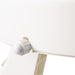 Close-up of a white lampshade with a beige geometric pattern on a white background