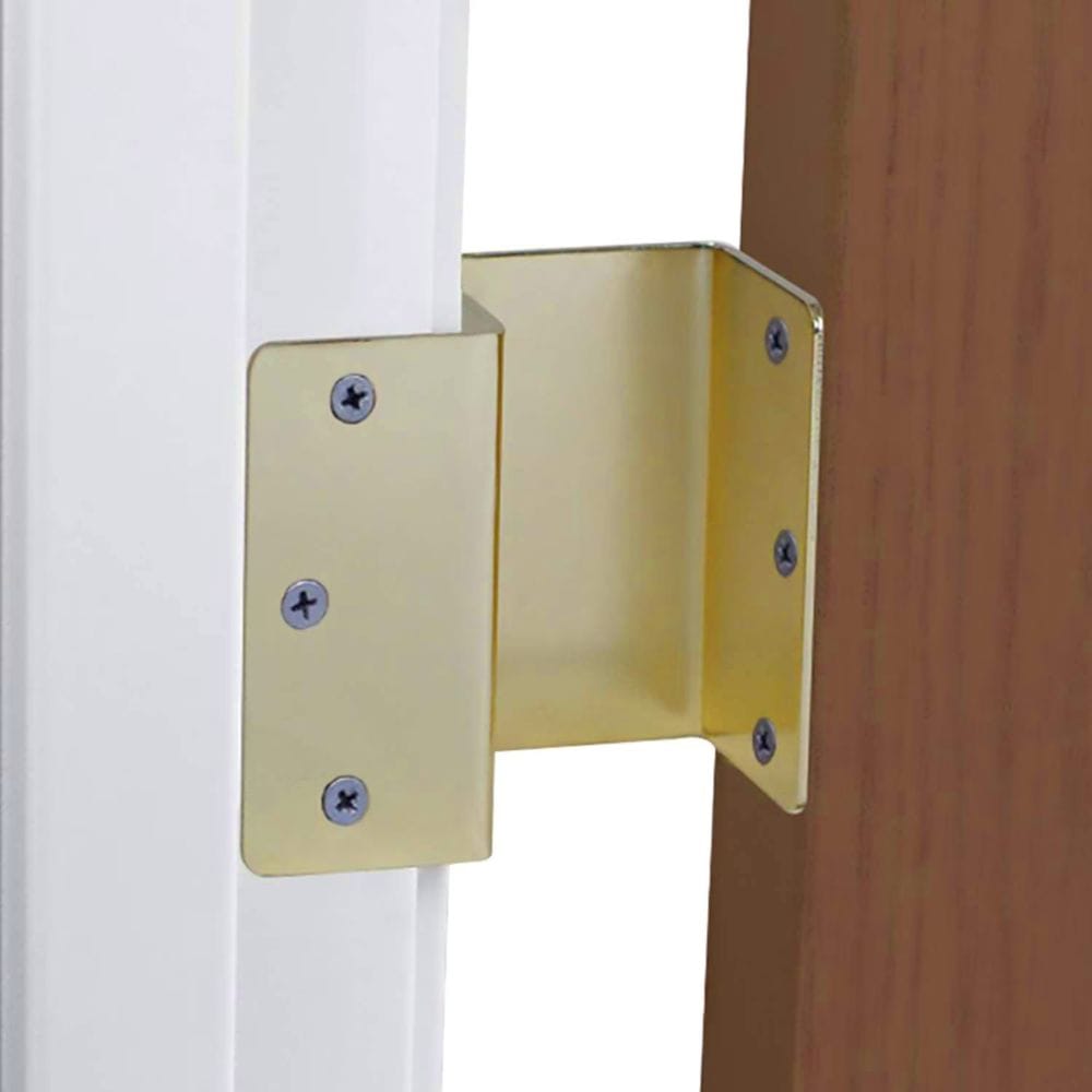 Gold corner bracket attached to a wooden surface with screws.