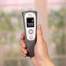 Digital thermometer held by a hand with a blurred background