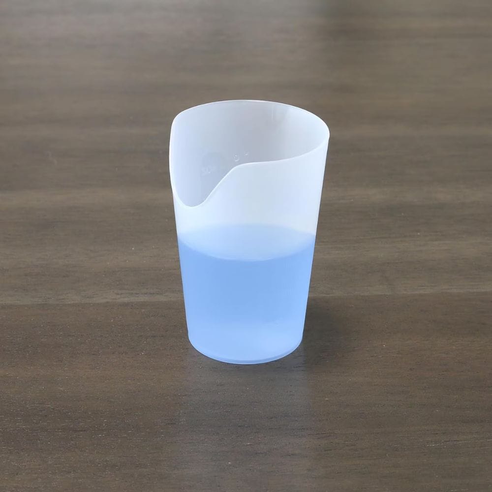 Silicone cup with blue liquid on a wooden surface