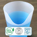 Silicone cup with blue liquid and safety certification labels on a wooden surface