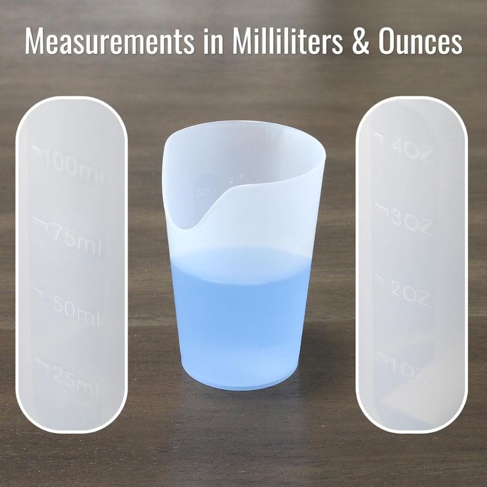 Three measuring cups with liquid, showing measurements in milliliters and ounces on a wooden surface.