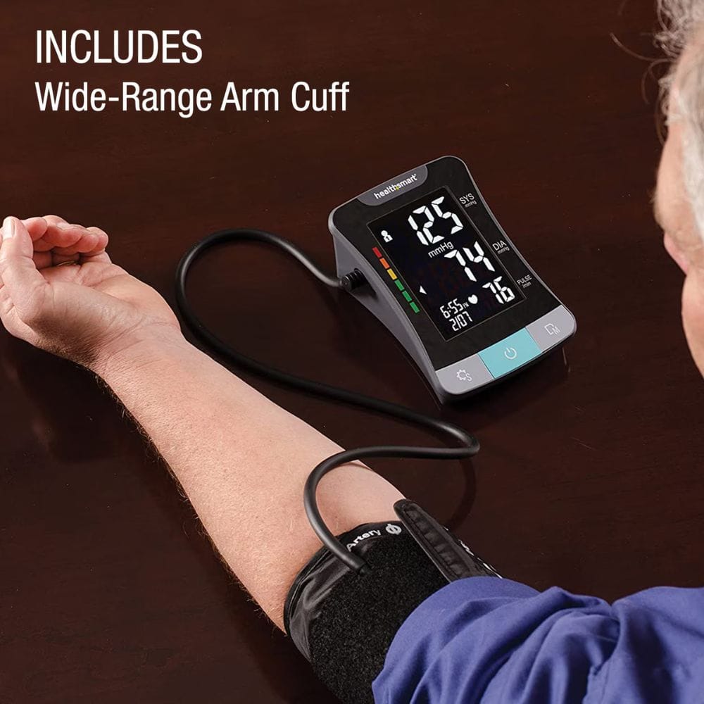 Digital blood pressure monitor on a person's arm with text 'Includes Wide-Range Arm Cuff'.