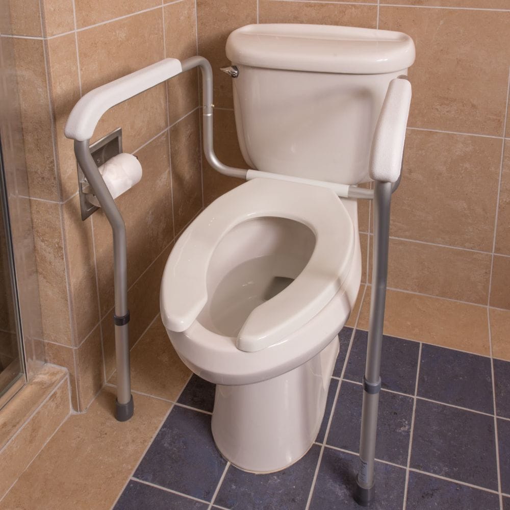 Toilet with a grab bar installed on a tiled bathroom floor.