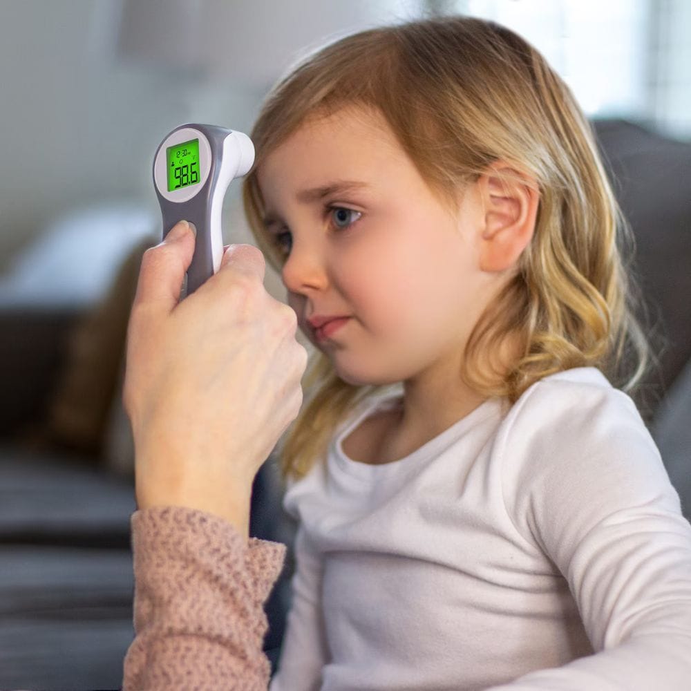 Child having their temperature taken with a digital thermometer.