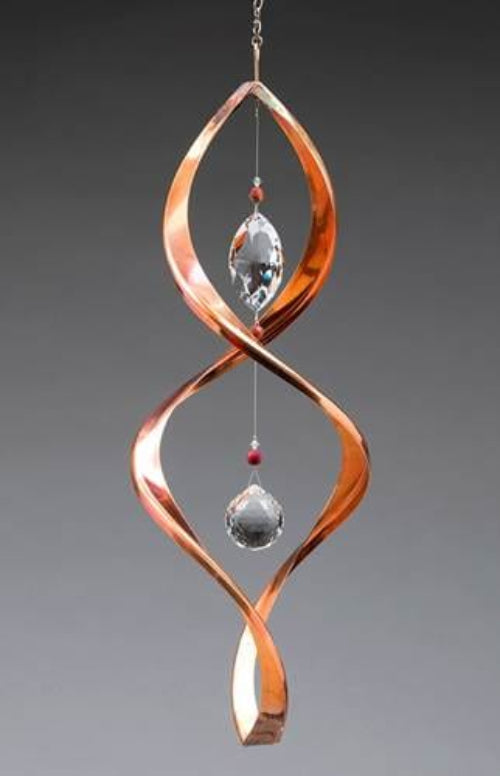 Copper wind chime with crystal beads on a gray background