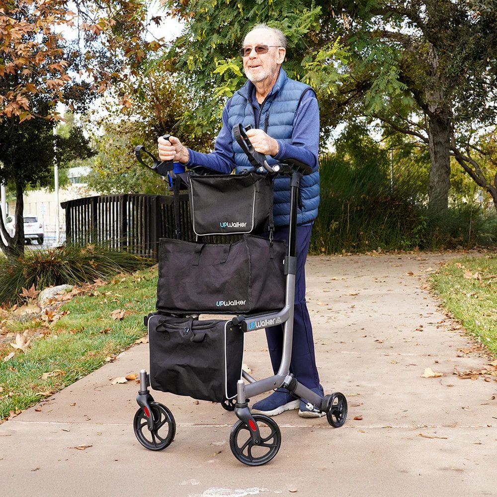 Man using a rollator with bags in an outdoor setting