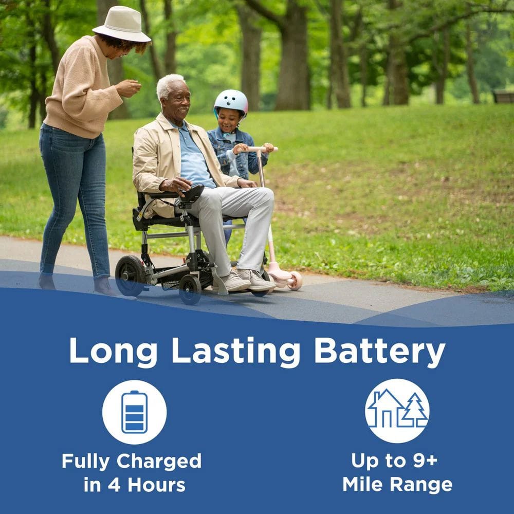Person using a power wheelchair with a child and another person in a park, promoting long-lasting battery life.