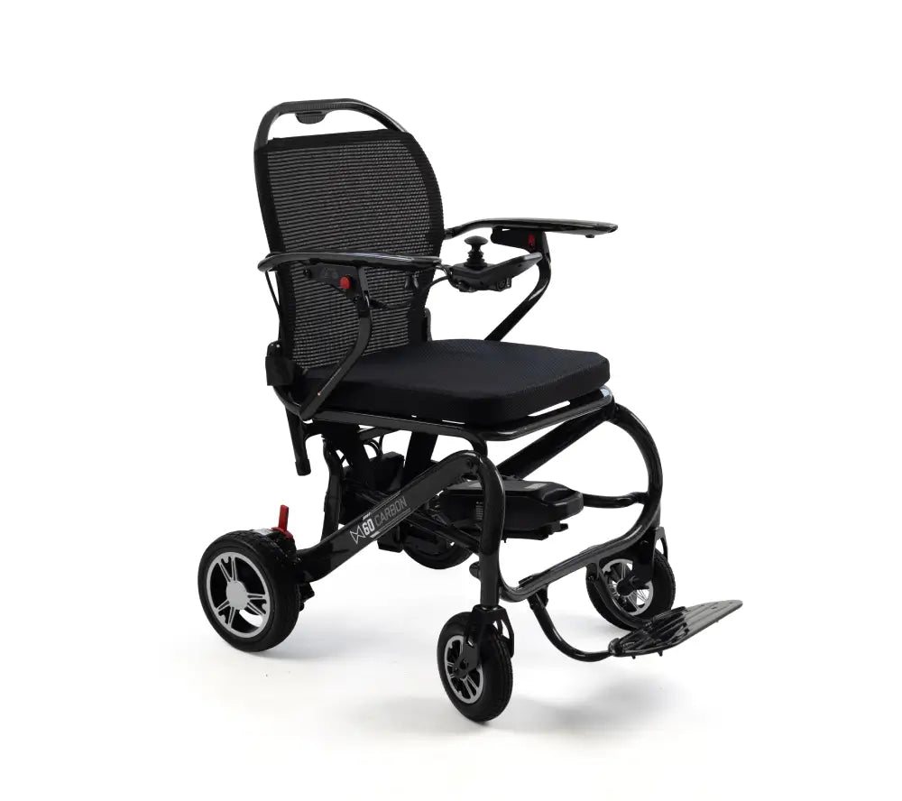 A black electric motorized wheelchair with a mesh backrest, padded seat, armrests, and fold-out footrest, photographed on a clean white studio background.