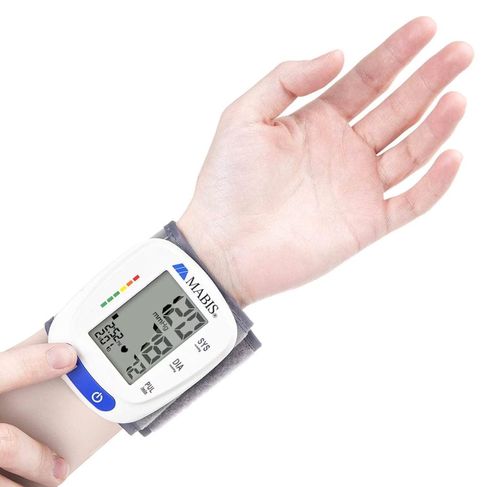Digital blood pressure monitor on a wrist with a white background