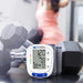 Mabis blood pressure monitor with dumbbells in a gym setting