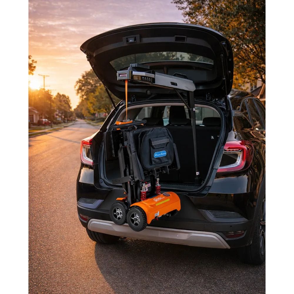 Car trunk with a tire inflator and toolbox during sunset.