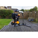 Garden leaf blower on a wooden deck with a garden and house in the background