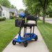 Blue mobility scooter with a basket on a sidewalk in a residential area