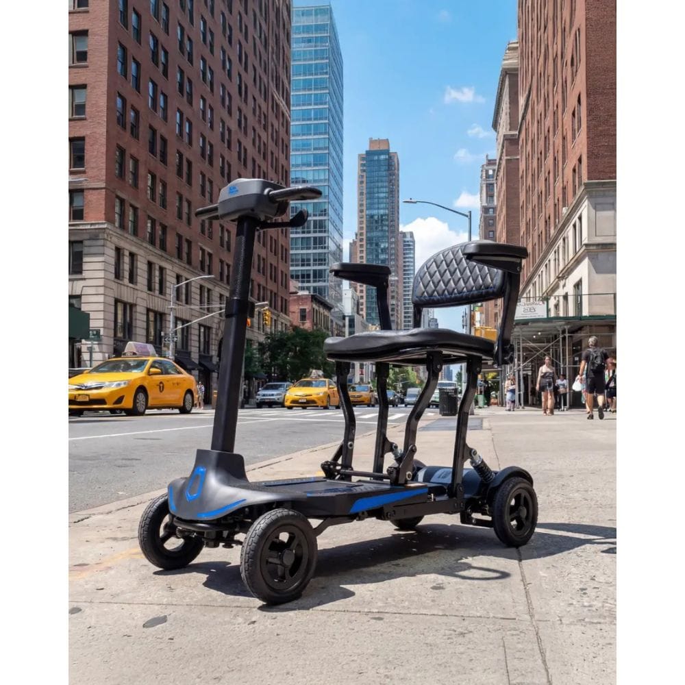 Electric scooter on a city street with tall buildings and a clear sky.
