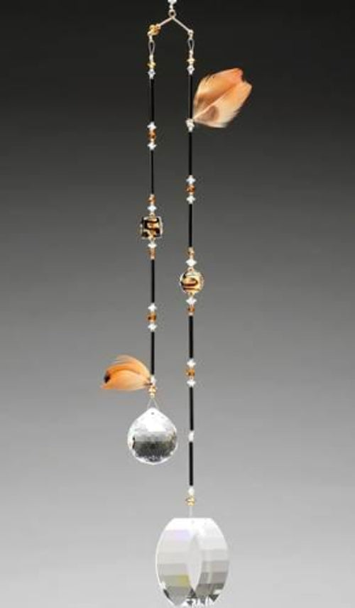 Decorative hanging with crystal balls and beads on a gray background