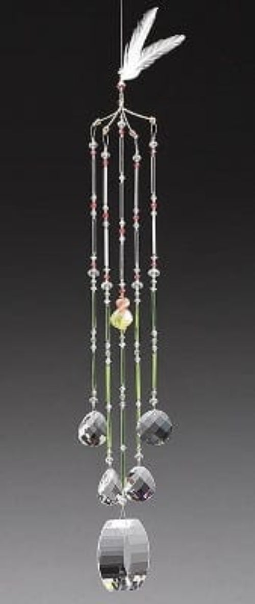 Decorative hanging mobile with crystals and a feather on a black background