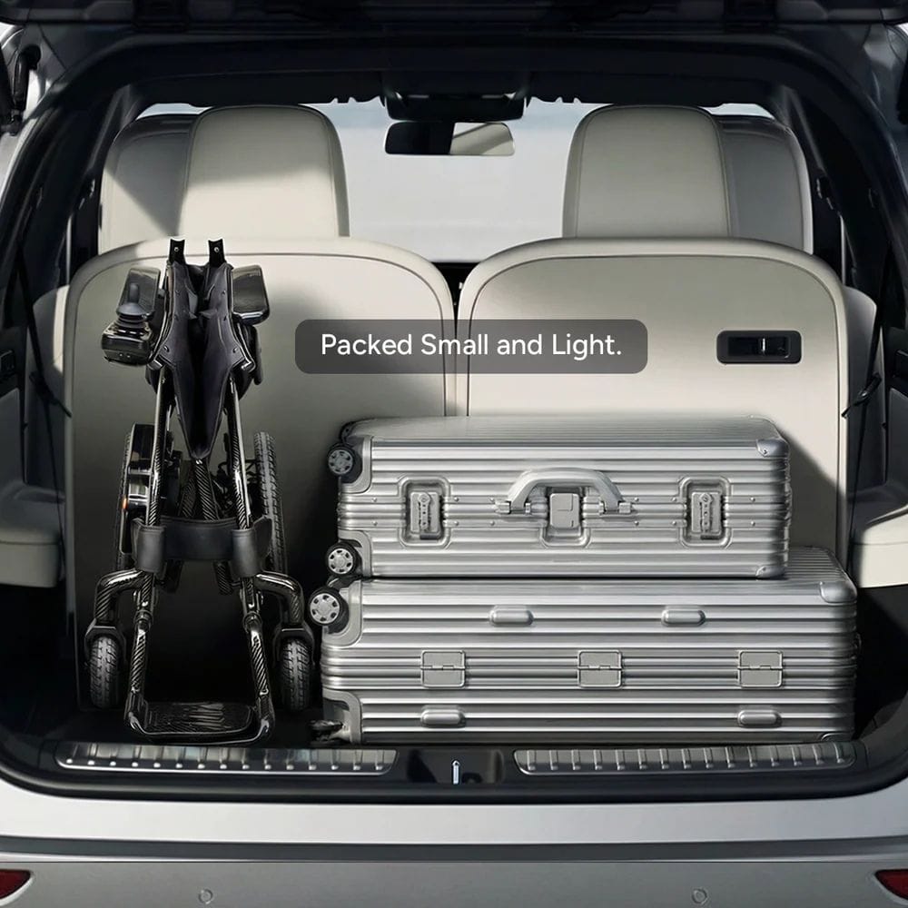 Trunk of a vehicle with suitcases and a bike, labeled 'Packed Small and Light'.