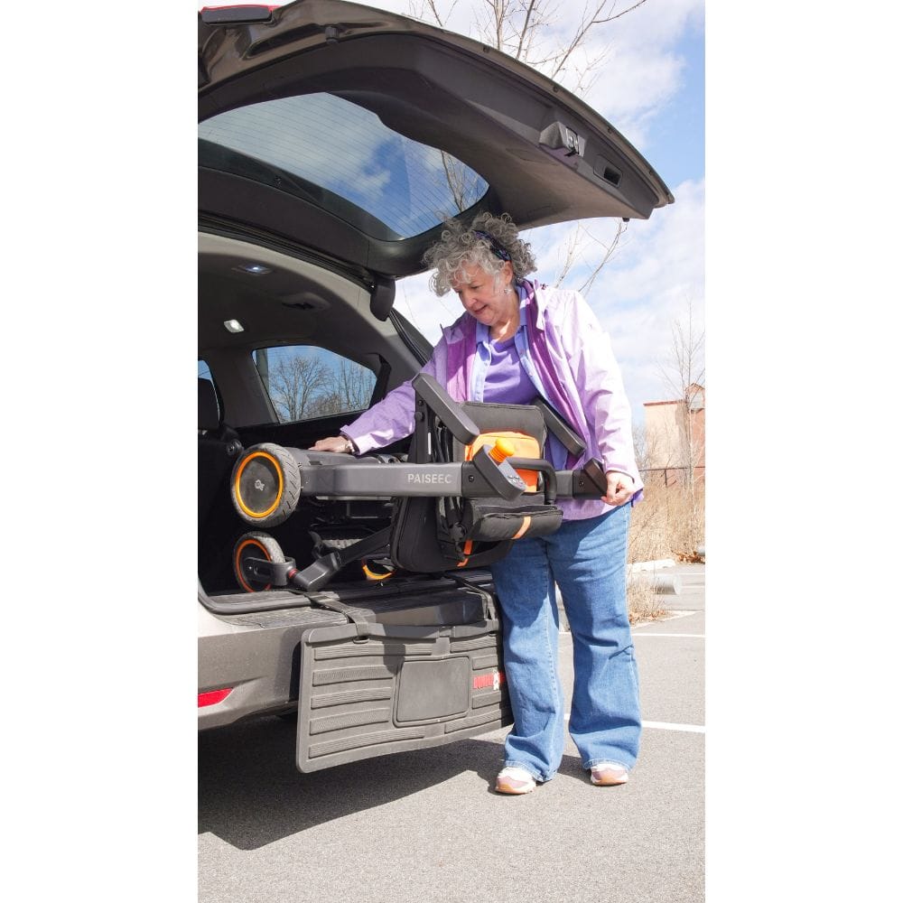 Person using a car seat carrier system in a vehicle trunk.