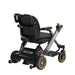 Black and gray mobility scooter with orange accents on a white background