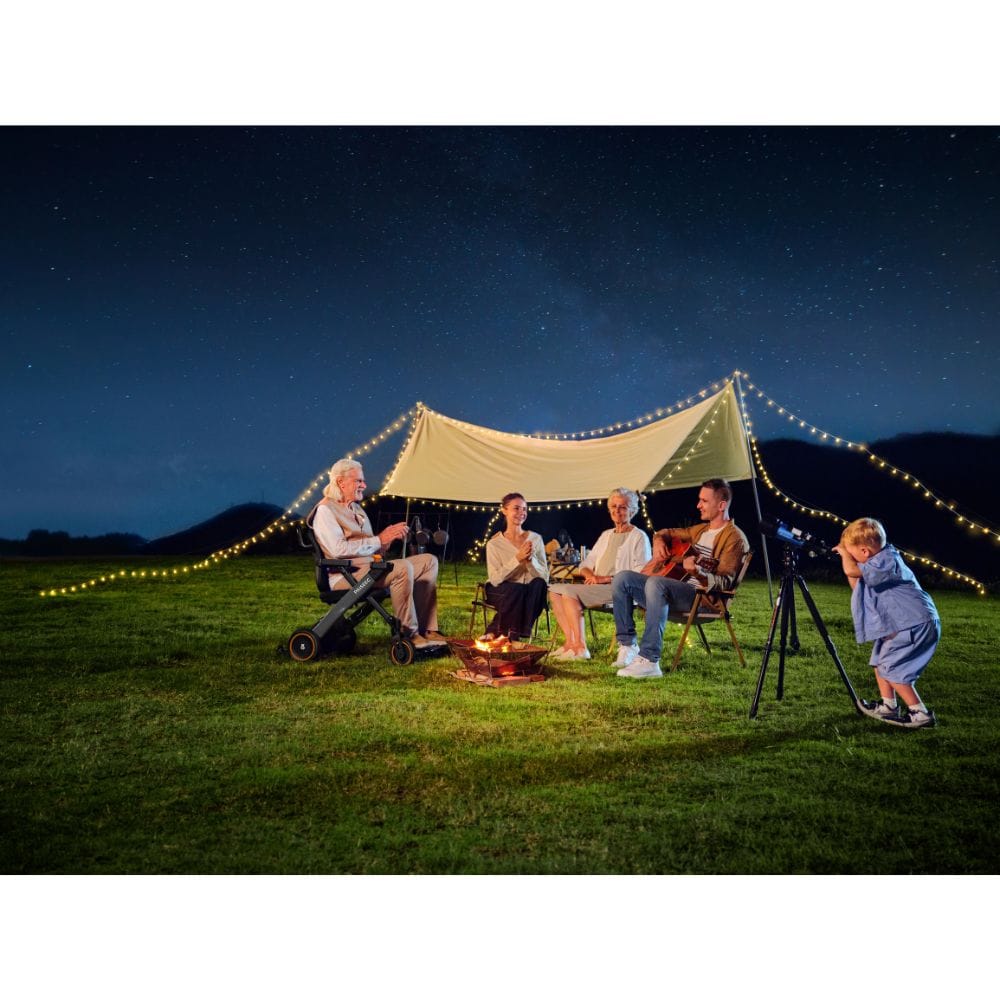 Family camping under a starry sky with a tent and string lights.