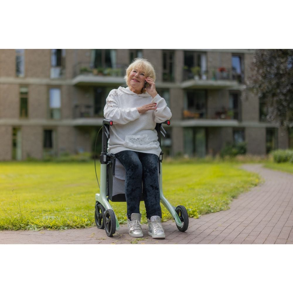 Woman using a mobility scooter outdoors with a building in the background