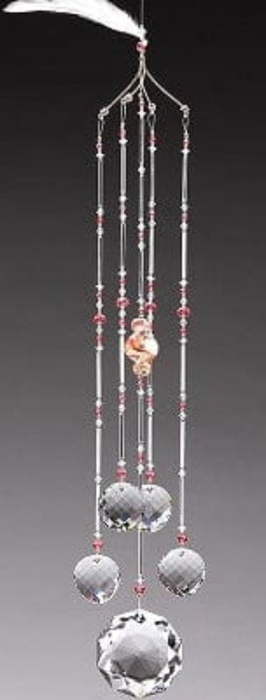 Decorative wind chime with crystal beads and a small figurine on a gray background