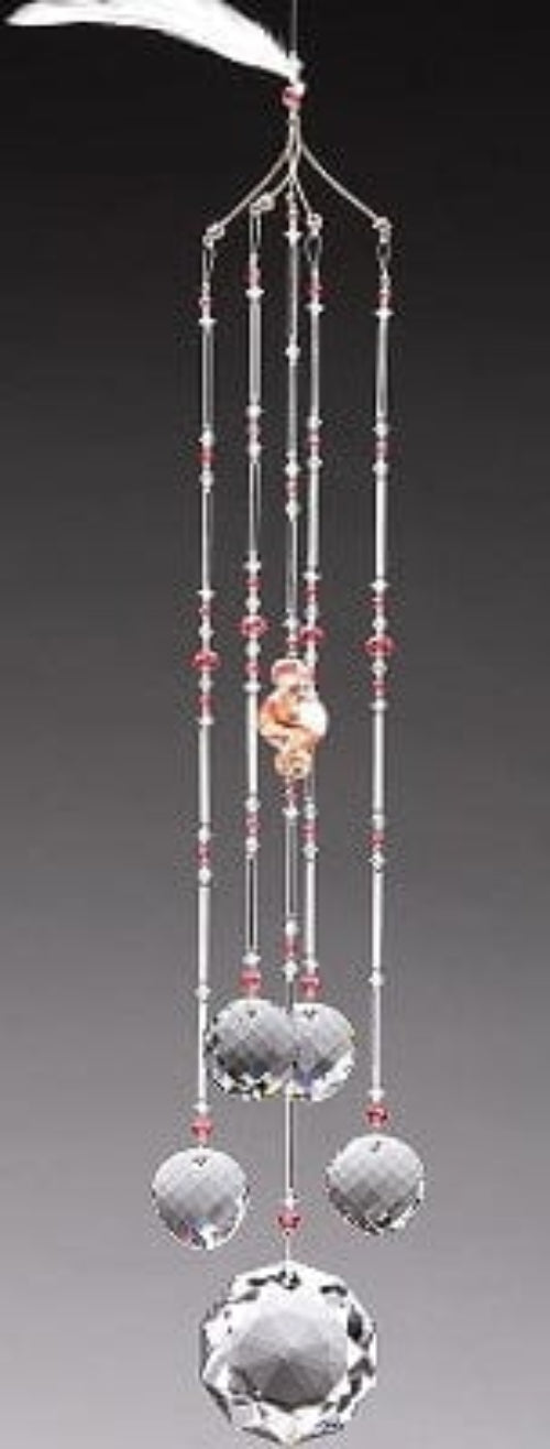 Decorative wind chime with crystal beads and a small figurine on a gray background