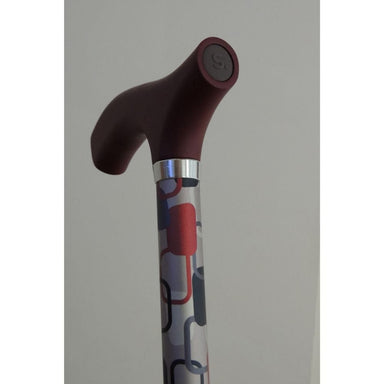 Cane with a patterned handle on a plain background