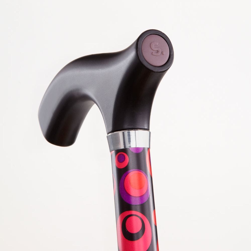 Black walking cane with colorful handle on a white background