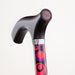 Black walking cane with colorful handle on a white background