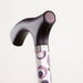 Cane with a patterned handle on a light gray background