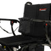 Black wheelchair with storage bags on a white background