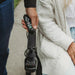 Person holding a remote control device with a blurred background