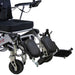Electric wheelchair with footrests and a basket on a white background