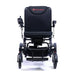 Black electric wheelchair with 'TravelBuddy' branding on a white background
