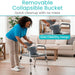 Woman using a walker with a removable collapsible bucket in a living room setting.