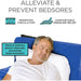 Man lying on a blue mattress with text about alleviating and preventing bedsores.