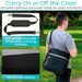 Person carrying a black bag with an adjustable shoulder strap in an outdoor setting