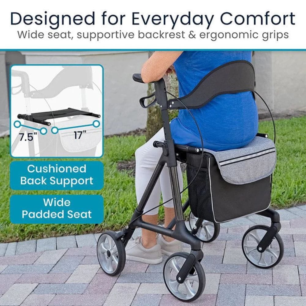 Person using a rollator with cushioned back support and wide padded seat, on a sidewalk.