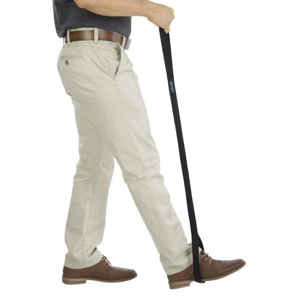 Person wearing beige pants with a black cane on a white background