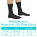 Black socks worn with a measurement chart for shoe size based on USA standards.