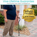 Person holding a cane with 'Vive Health Lifetime Guarantee' badge in front of a house.